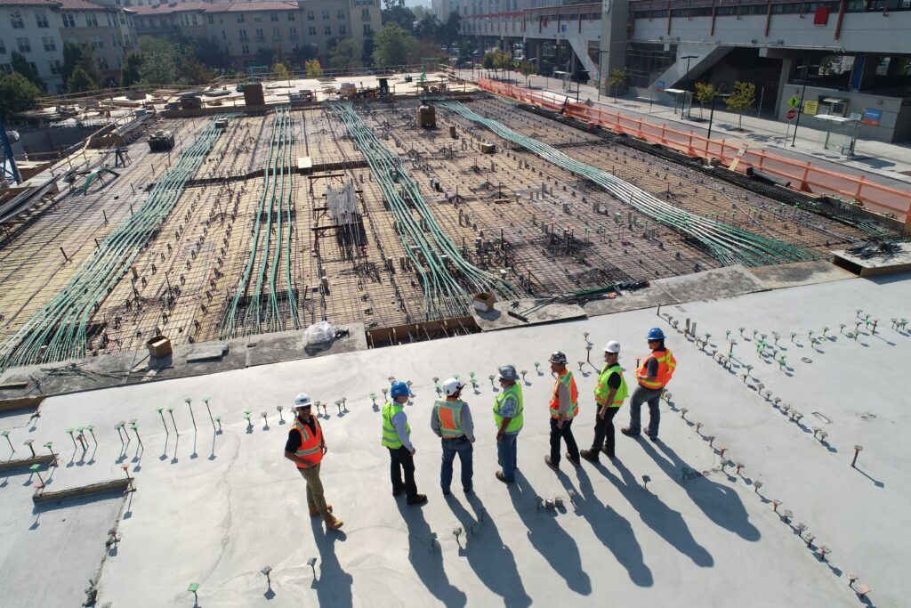 a drone shot of a group of workers on a building site