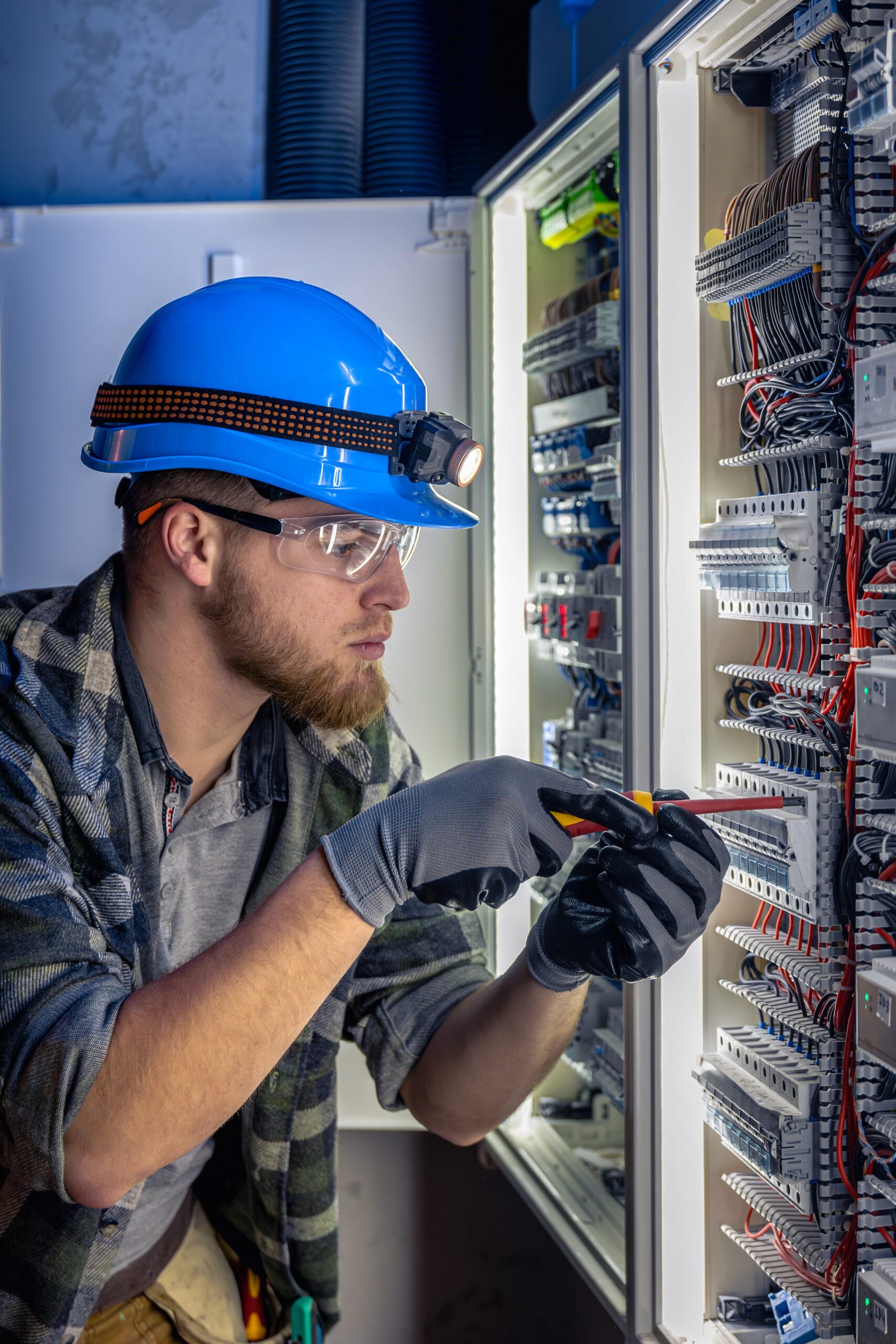An electrician working on a circuit board