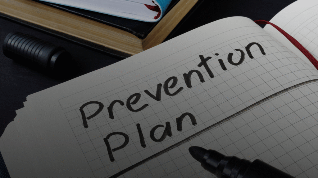 A note pad and pen with prevention plan written down.