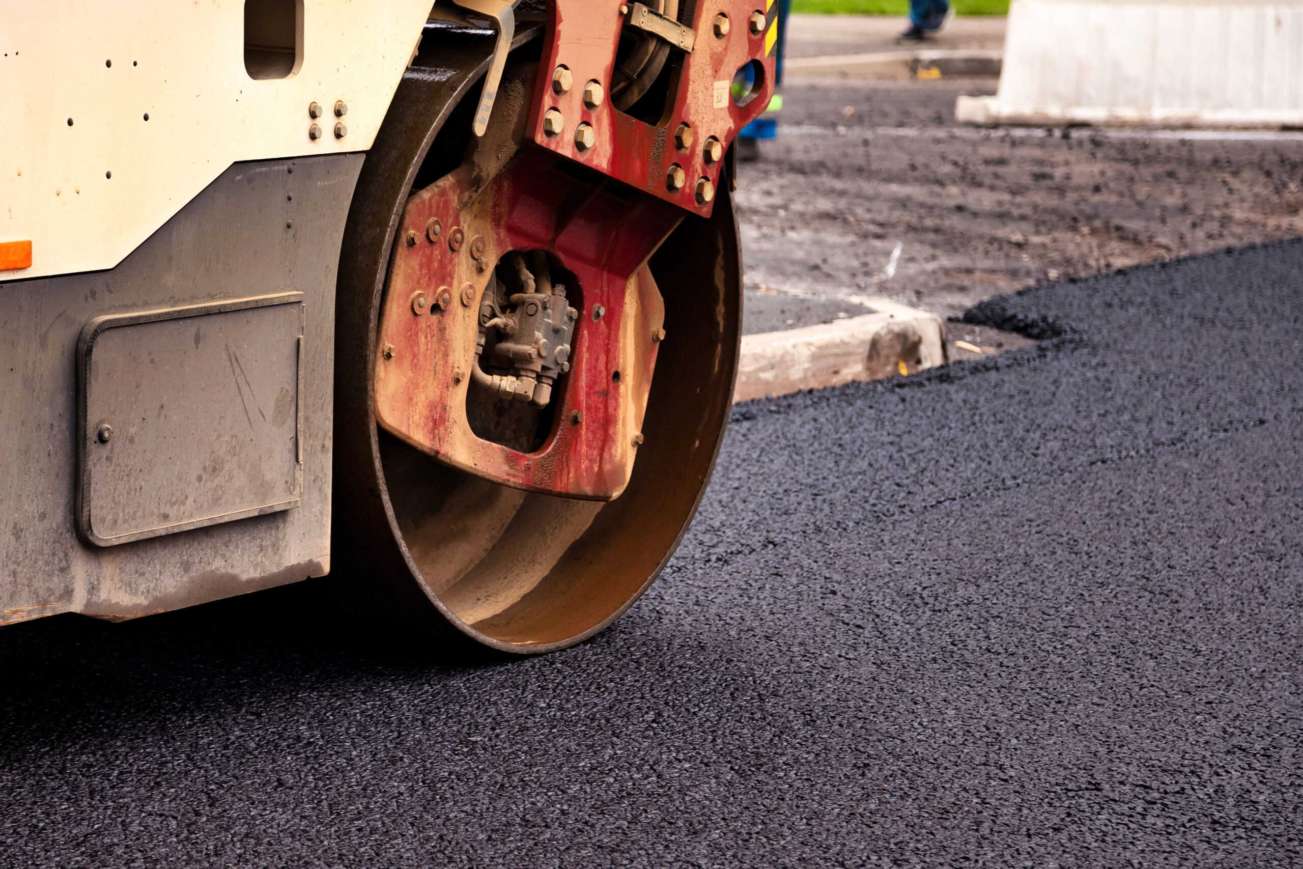 Asphalt is being smoothly rolled out on a city street